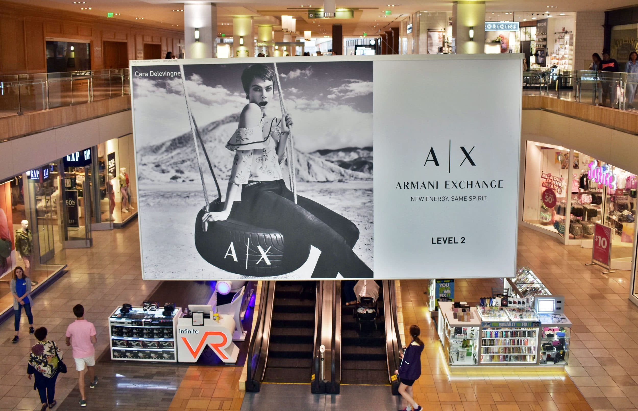 Armani Exchange — Cara Delevingne mall banner above the escalators